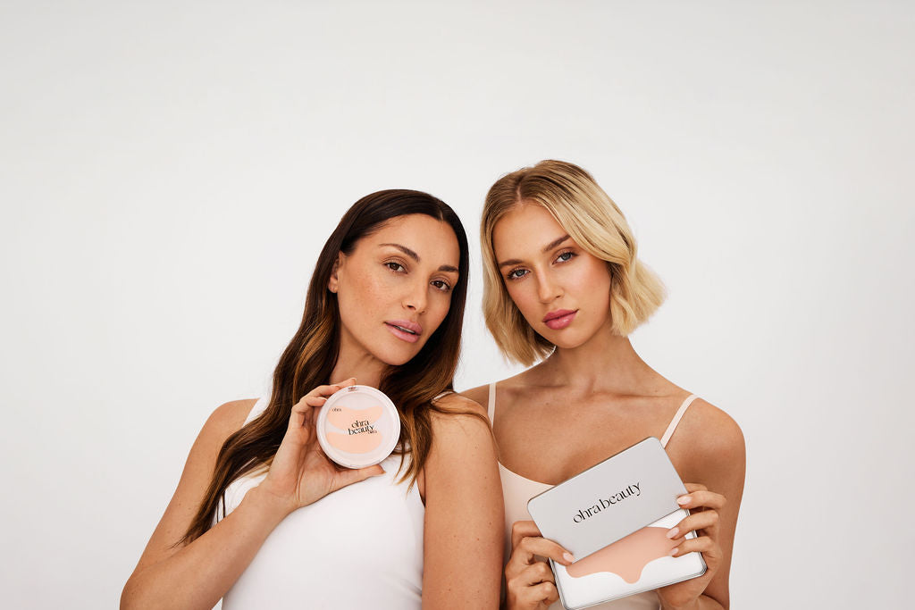 Two women holding the Self Made Eye Mask and Lifted Forehead Mask, Ohra Beauty reusable skincare masks