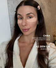 Brunette woman wearing the Ohra Self Made Eye Mask and Untouched Hair Clips together during her morning skincare routine