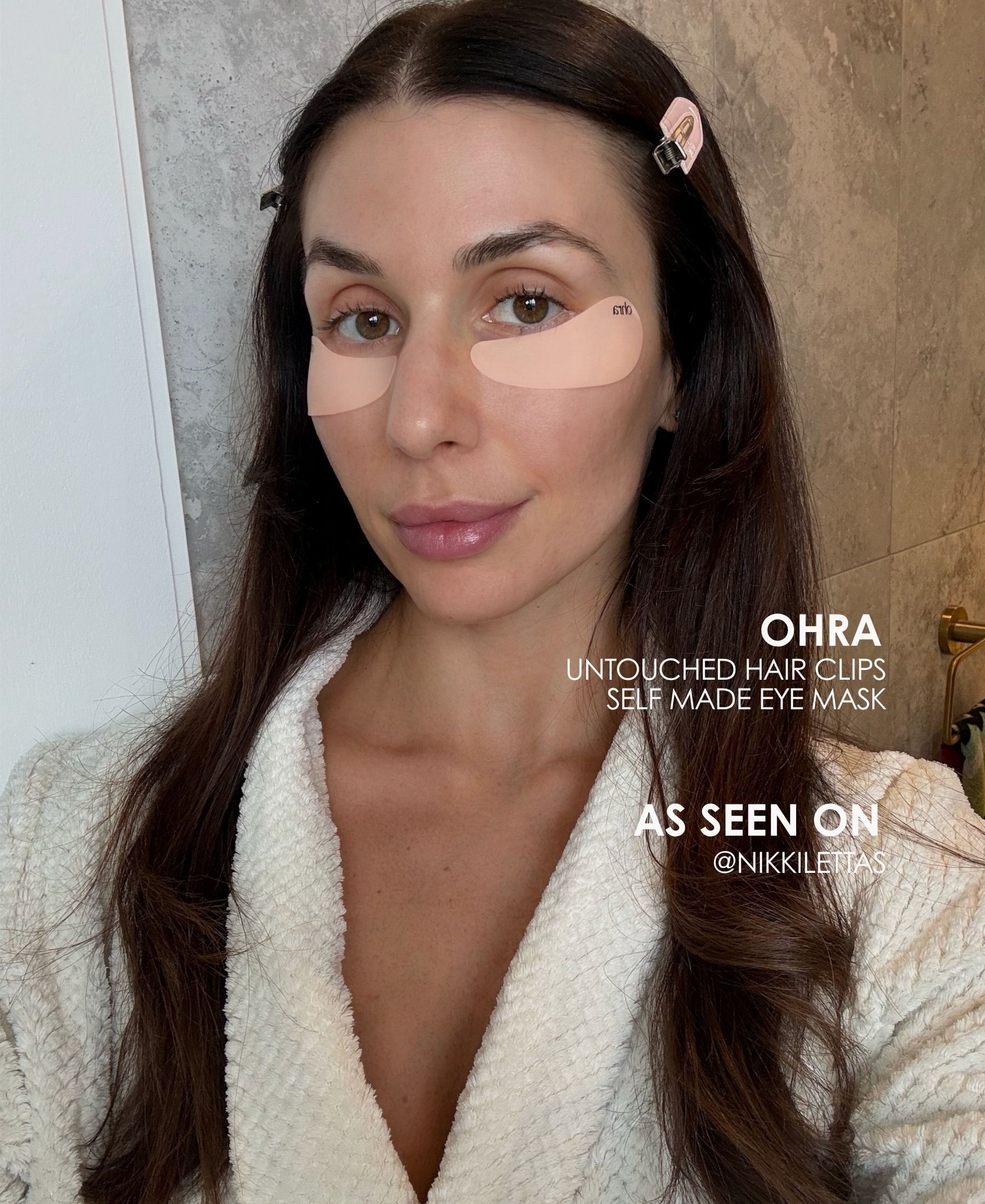 Brunette woman wearing the Ohra Self Made Eye Mask and Untouched Hair Clips together during her morning skincare routine