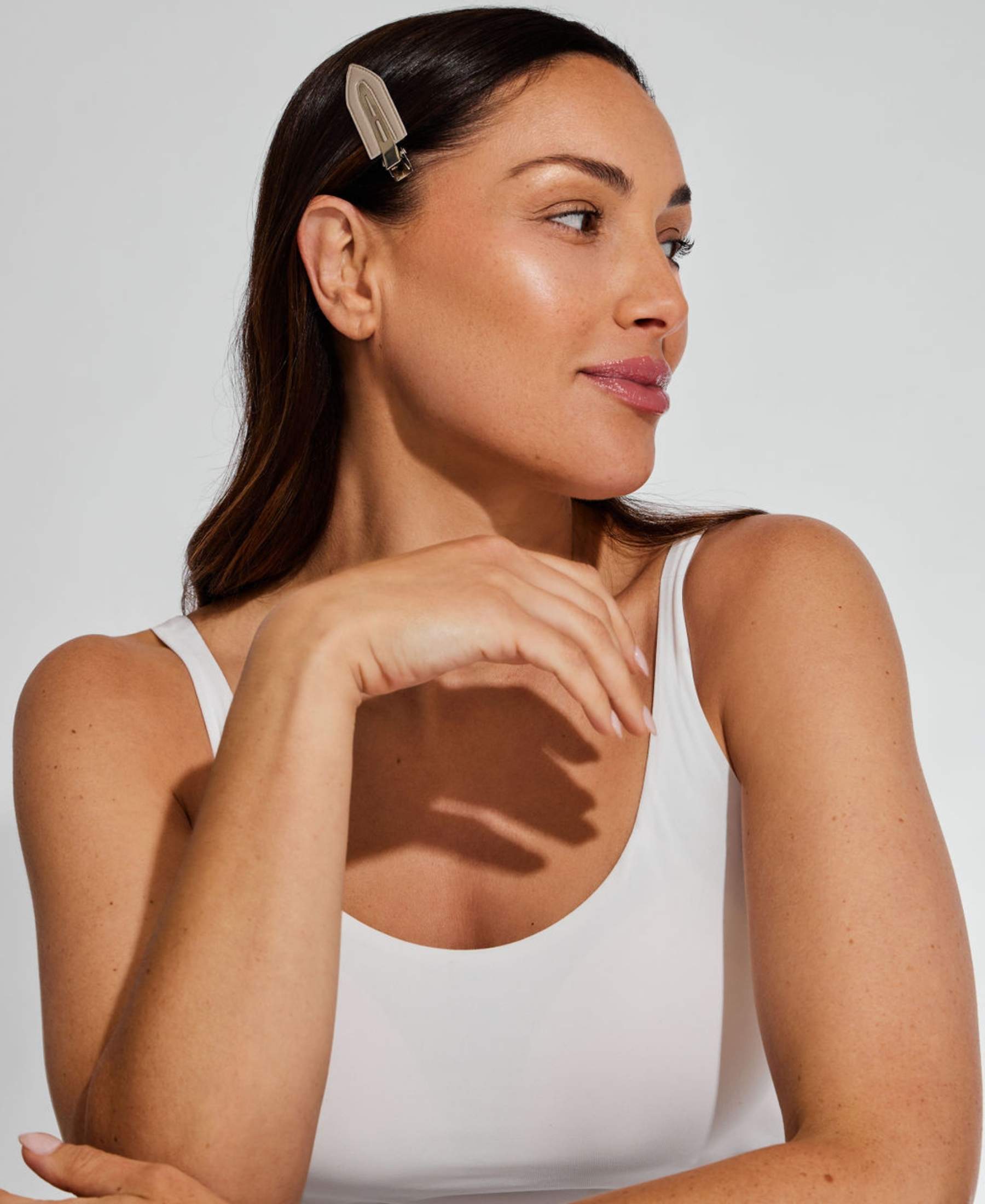 Woman wearing Ohra Smokey Untouched Hair Clips during her skincare routine