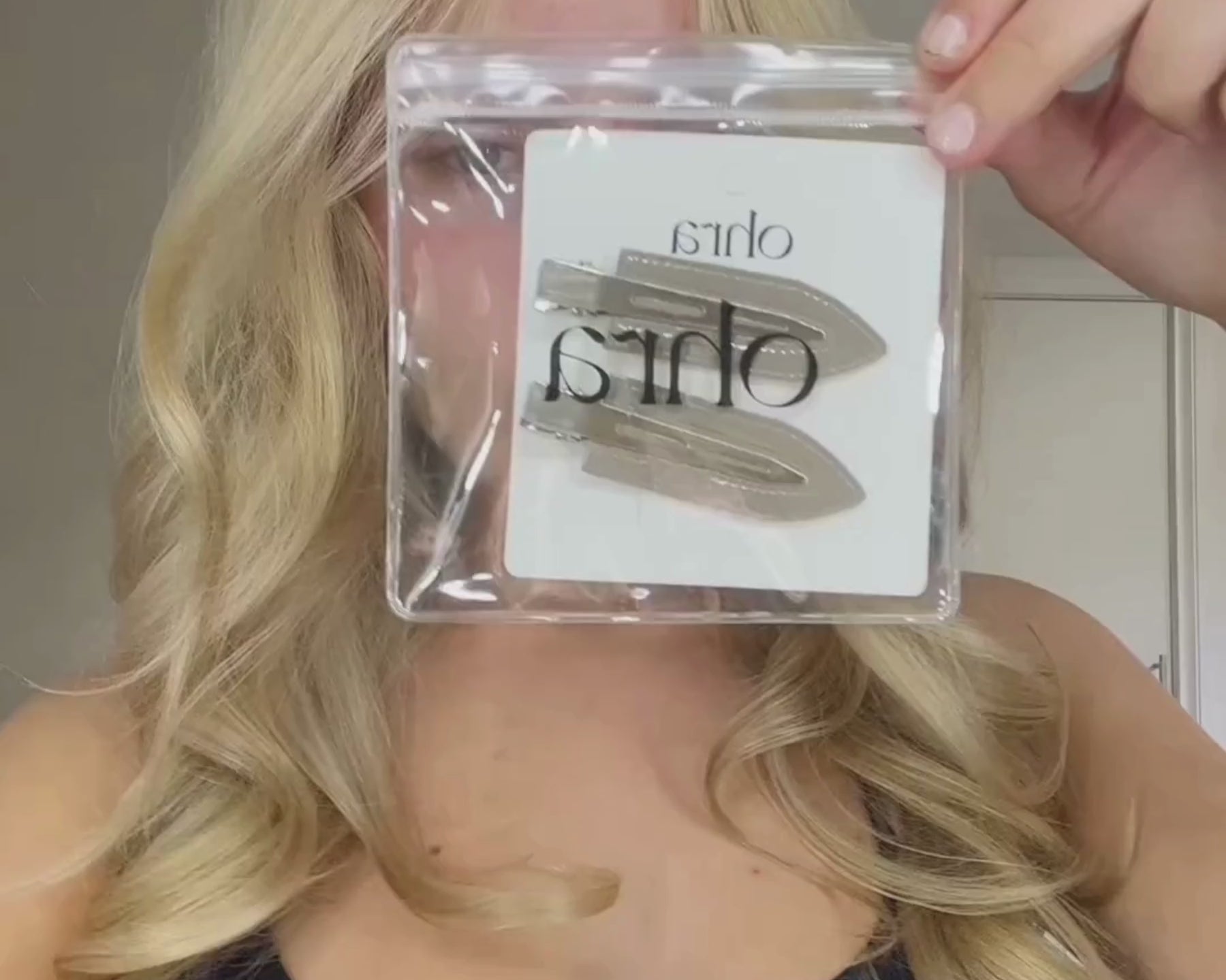 Video of a woman applying Ohra Untouched Hair Clips in Smokey during her makeup routine
