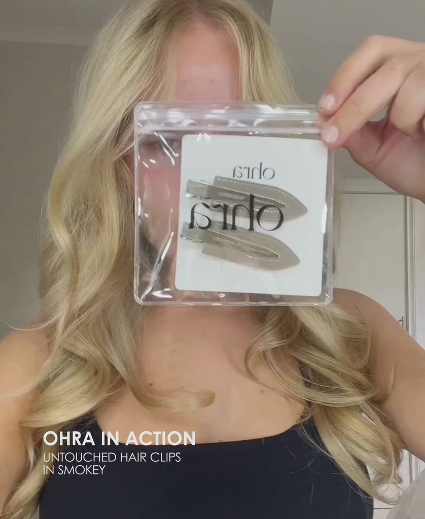 Video of a woman applying Ohra Untouched Hair Clips in Smokey during her makeup routine
