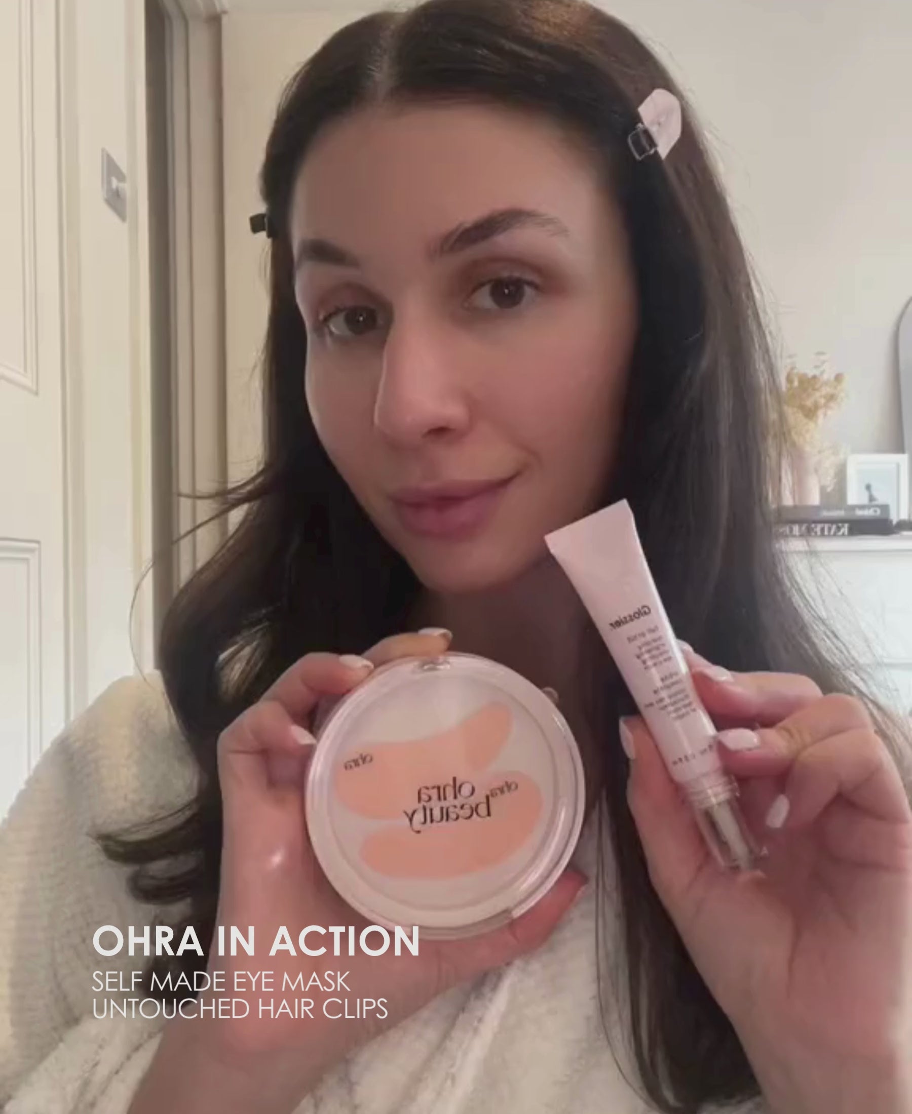 Video of a woman demonstrating how to use the Ohra Self Made Eye Mask, reusable silicone under-eye mask for de-puffing and hydration. Using Ohra Untouched Hair Clips in Blush.