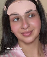 Video of a woman applying the Ohra Lifted Forehead Mask and Untouched Hair Clips in Blush during her skincare routine