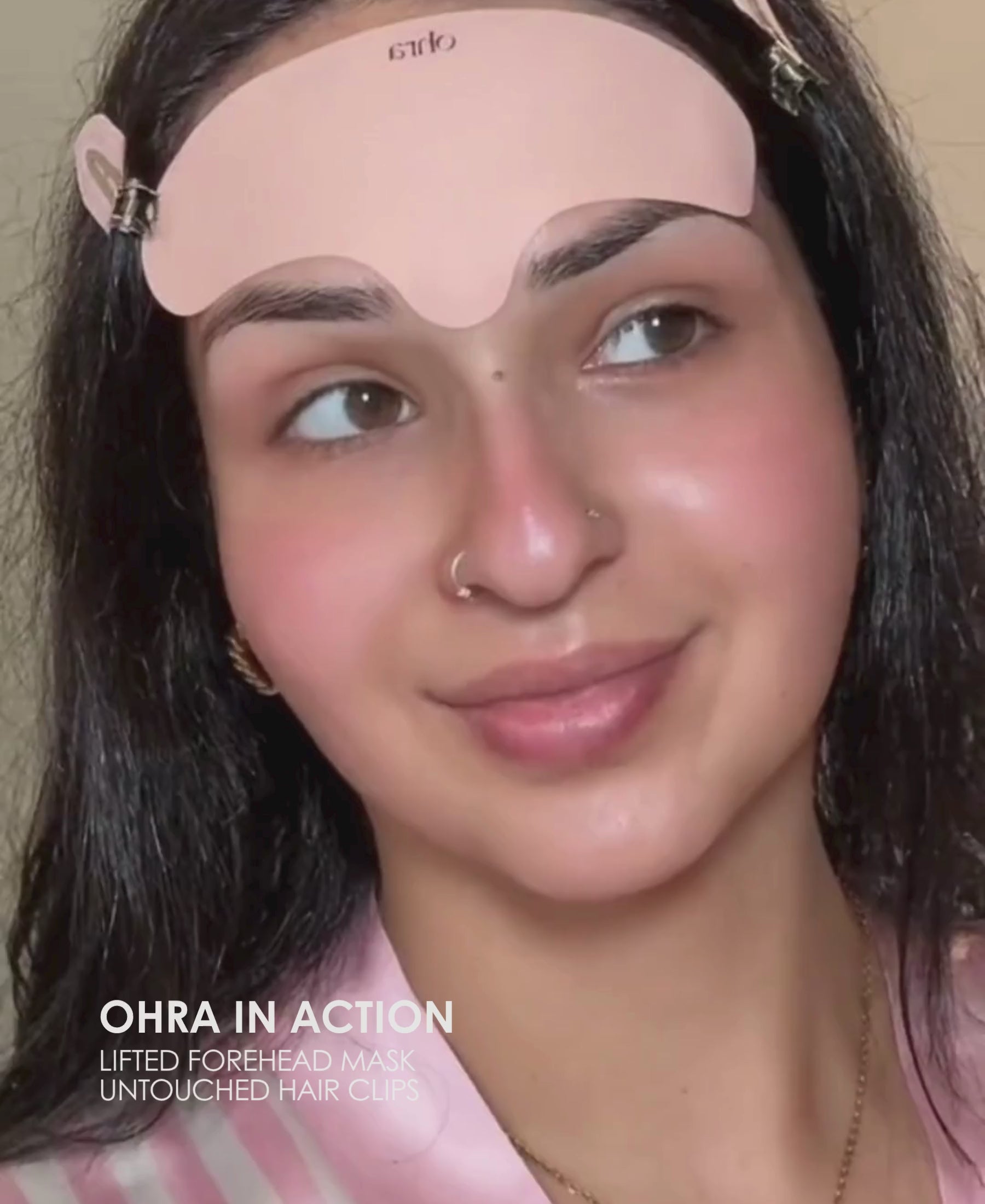 Video of a woman applying the Ohra Lifted Forehead Mask and Untouched Hair Clips in Blush during her skincare routine